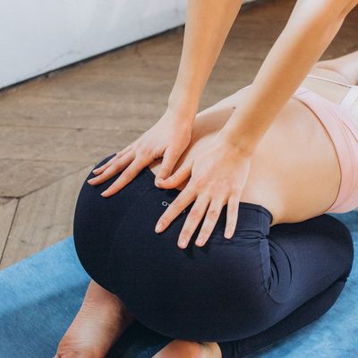 Detail shot of hands and feet on a yoga mat.