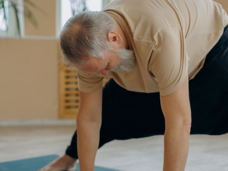 Person moving gracefully through a yoga sequence in a bright, airy room.